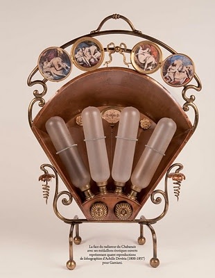 A VARNISHED BRASH RADIATOR FROM THE FORMER BROTHEL LE CHABANAIS WITH EROTIC IMAGERY