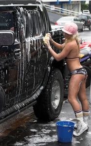 Washing a car in a bikini.