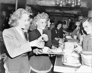 Marlene Dietrich and Rita Hayworth serve food to soldiers at the Hollywood Canteen in 1942