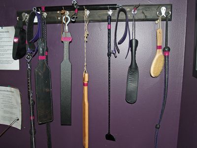 Chastisement implements hanging on a wall.
